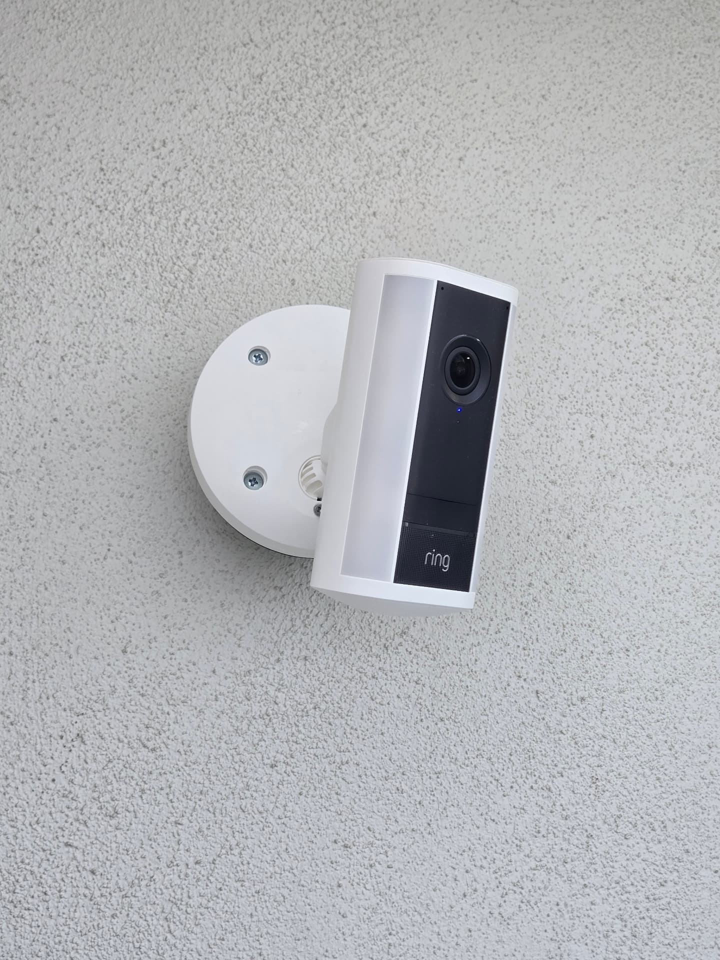 Customer-supplied Ring wireless camera cleanly mounted on a stucco wall